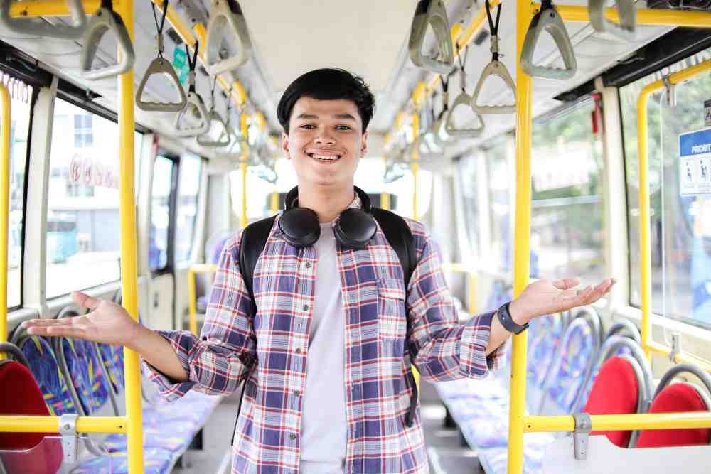 A young man in a bus.