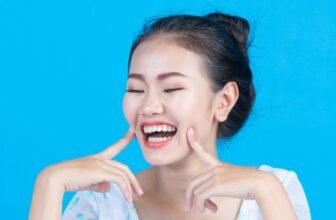 A young woman smiling with beautiful white teeth.